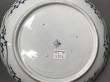 a white plate with blue designs on it sitting on a table