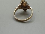 an image of a gold ring with a stone in the center