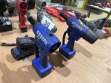 two electric tools sitting on a table in a room
