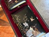 two black and gold cases in a red case
