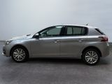 the silver car is parked on the concrete floor in the room