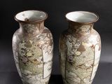 two vases sitting side by side on a black surface