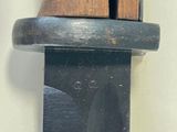 a close up of a knife hanging on a wall
