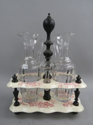 Porte-huilier en faïence fine à décor rose et bois noir tour…