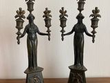 pair of antique bronze candlesticks of the person