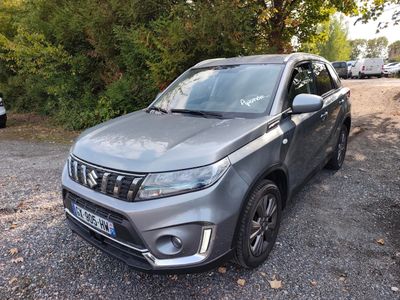 a grey suv parked in a parking lot next to a forest