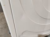 a white washer sitting on a pallet in a room
