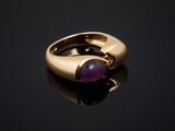 a close up of a gold ring with a purple stone