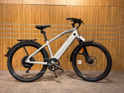 the electric bike is parked in front of a wooden wall