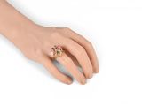 a close up of a person ' s hand with a ring on it