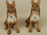 two figurines of dogs sitting next to each other