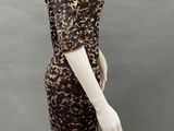 a mannequin wearing a leopard print dress and hat