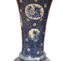 a blue and white vase sitting on a white surface
