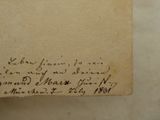 an old piece of paper with writing on it sitting on top of a table