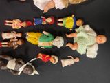 a lot of dolls that are sitting on a table