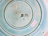 a close up of a blue plate with a number on it