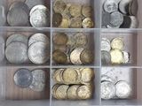 a plastic container filled with lots of coins on a table