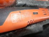 a close up of an orange and black electric tool