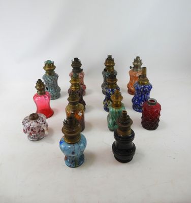 a lot of different colored vases sitting on a white surface