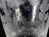 a glass vase with a picture of a deer in the woods