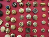 many different types of buttons on a red surface