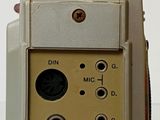 a close up of a small electronic device on a white surface
