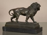 bronze statue of a lion on a marble base on a table