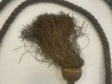 a rope with a knot and a piece of grass on it
