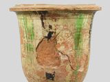 a very old vase with peeling paint on it
