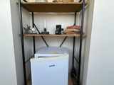 a small white box sitting on a shelf in a room