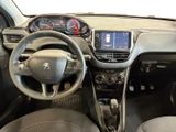 the interior of a small car with a steering wheel and dashboard