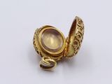 an image of a close up of a gold ring on a white surface
