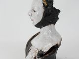 a black and white statue of a woman with a hat on