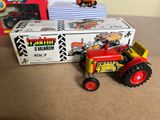 a toy tractor and a toy tractor in front of a box