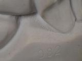 a close up of a statue of a dog with a collar