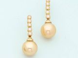 a pair of pearl and diamond earrings