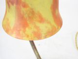 a yellow and orange lamp that is sitting on a table