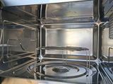 a close up of a stainless steel oven with the door open