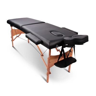a black massage table on a white background