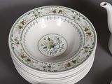 a lot of plates and a teapot on the table