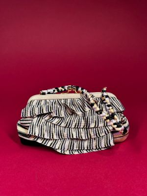a black and white purse with a chain on top of it