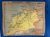 an old map of morocco hanging on a wall in a blue room