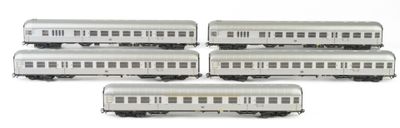 four silver train cars sitting on top of each other on a white surface