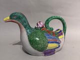 a ceramic duck that is sitting on a table