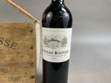 a bottle of wine sitting next to a wooden box