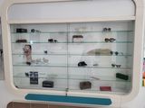 a display case with glasses and other items in it