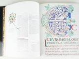 an open book with a picture of a letter c on it