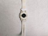 a close up of a watch with a white strap on it