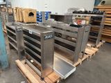many metal shelves that are stacked on pallets in a warehouse