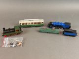 four toy trains that are sitting next to each other